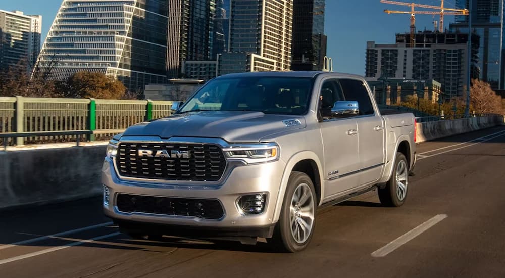 2025 Ram 1500 Tungsten driving down a road.