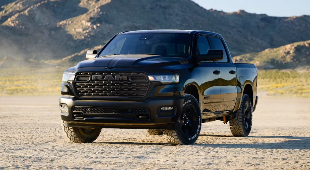 Black 2026 Ram 1500 driving off-road.