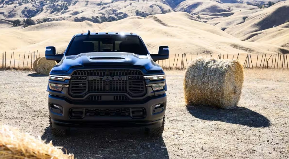 Black 2026 Ram 2500 parked by a hay bale