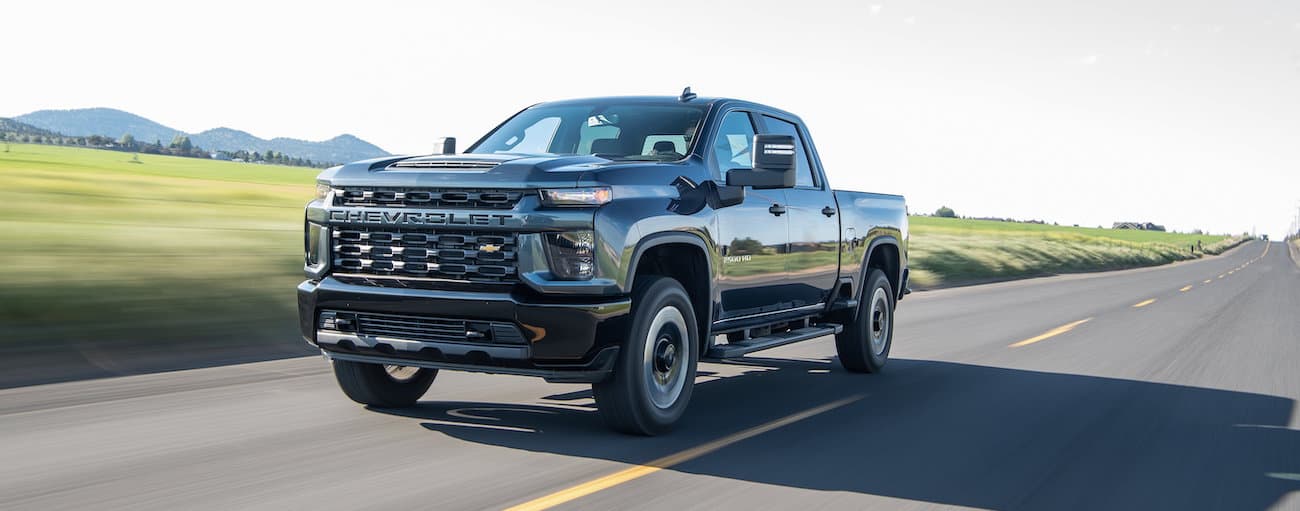 Black 2020 Chevy Silverado 2500 HD driving down an open road