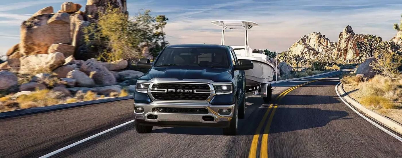 Blue 2026 Ram 1500 towing a boat
