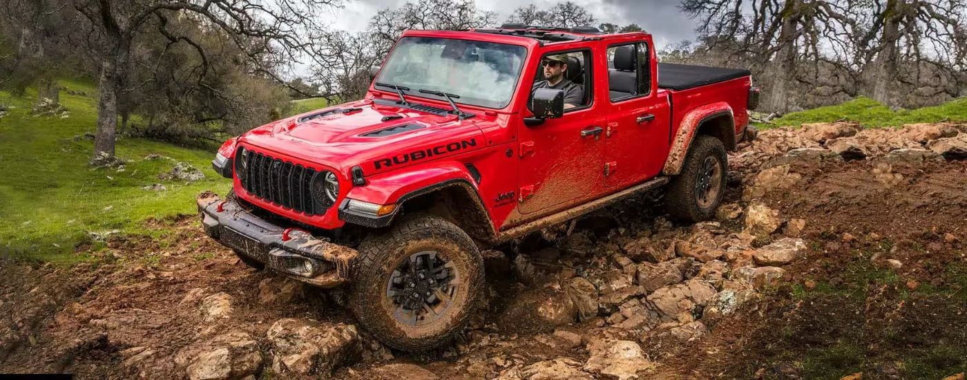 Red 20244 Jeep Gladiator Rubicon off-roading in mud