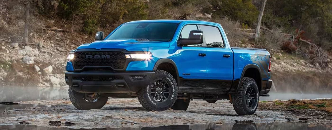 Blue 2026 Ram 1500 Rebel parked off-road at an angle