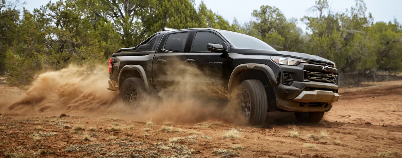 Black 2026 Chevy Colorado off-roading on a dusty trail