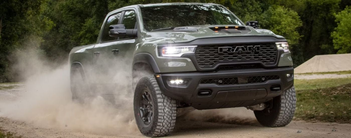 Green 2026 Ram 1500 RHO on a dirt road.