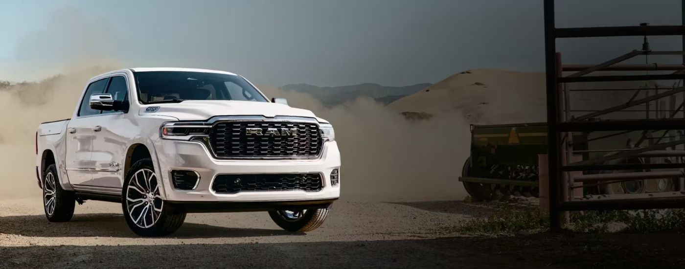 A white 2027 Ram 1500 Lone Star parked at a job site.