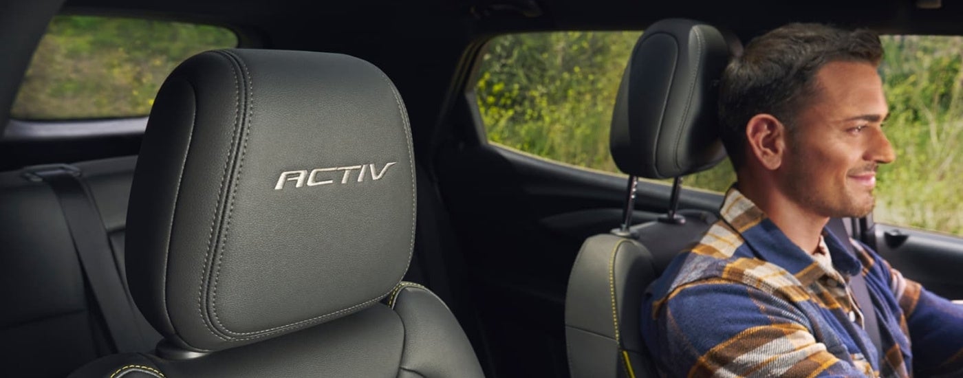 Smiling person driving a 2025 Chevy Trailblazer ACTIV