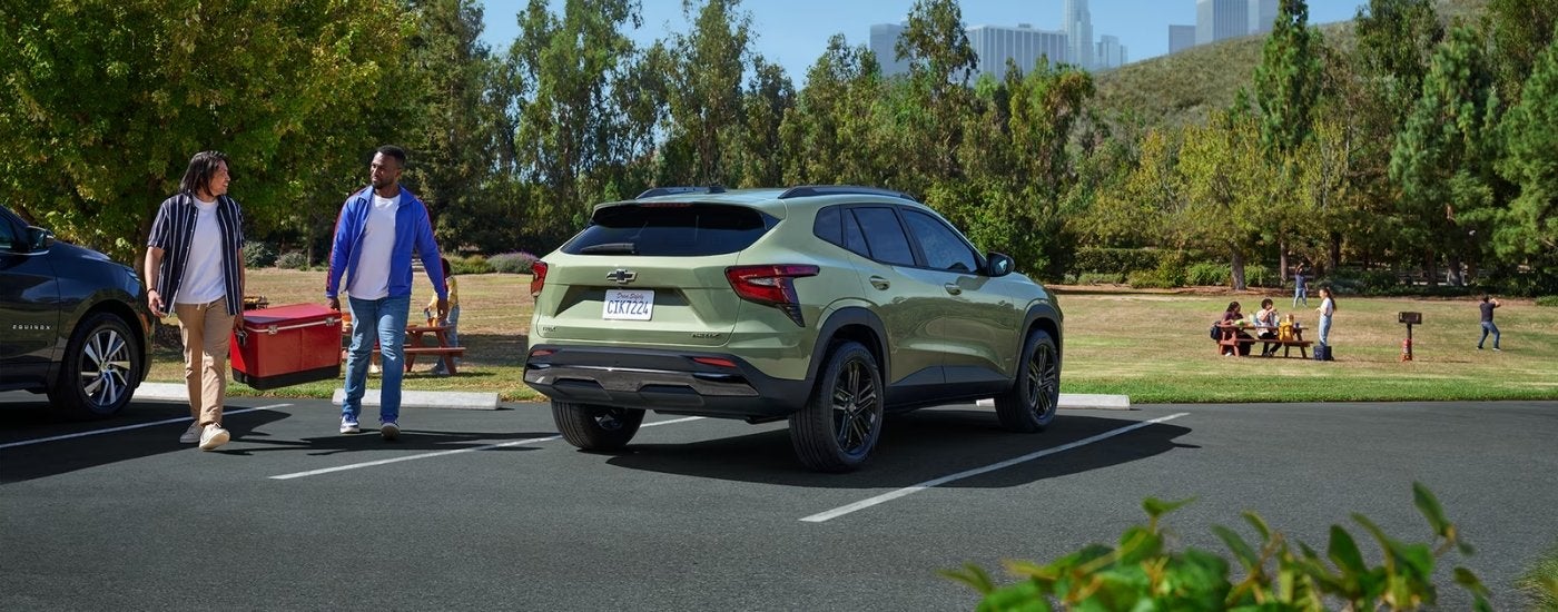 Green 2025 Chevy Trax ACTIV parked near a field