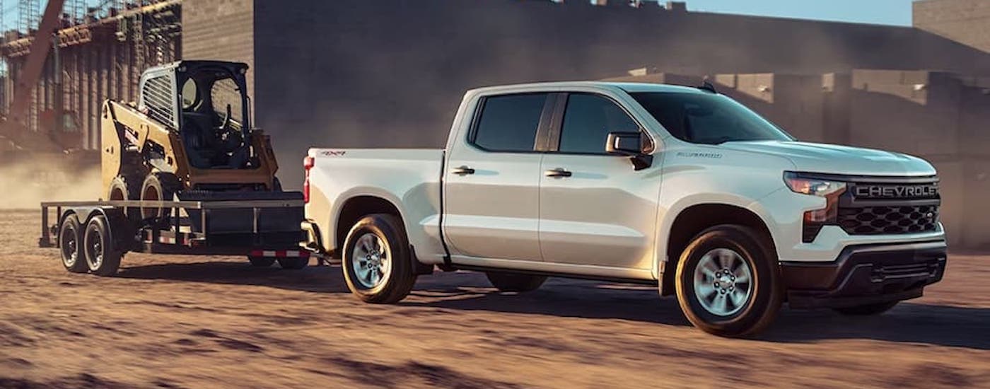 A white 2023 Chevy Silverado 1500 from the side.
