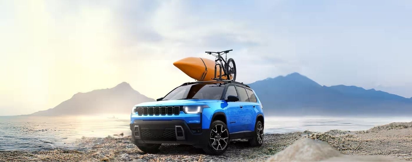 Blue 2026 Jeep Cherokee parked near mountains