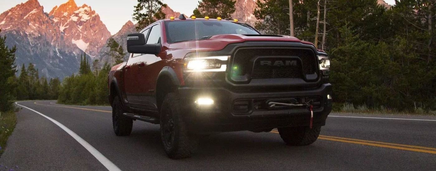 Red 2023 Ram 2500 Power Wagon is driving to a Ram dealer