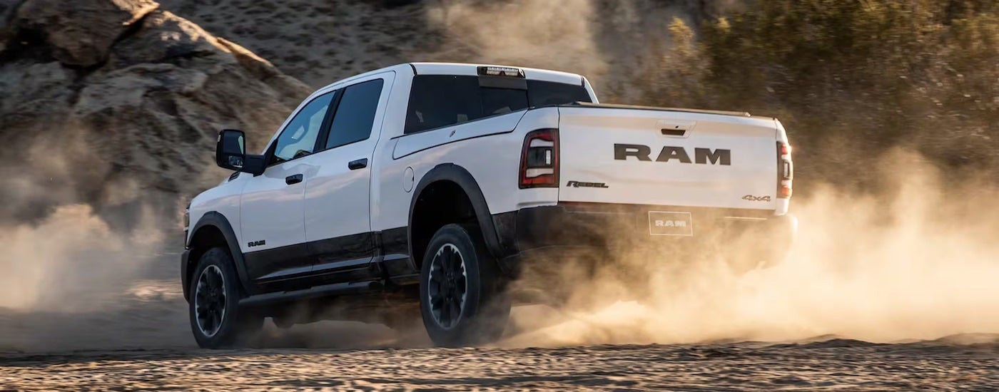 A white 2025 Ram 1500, a Ram truck for sale in Broken Bow, from the rear.