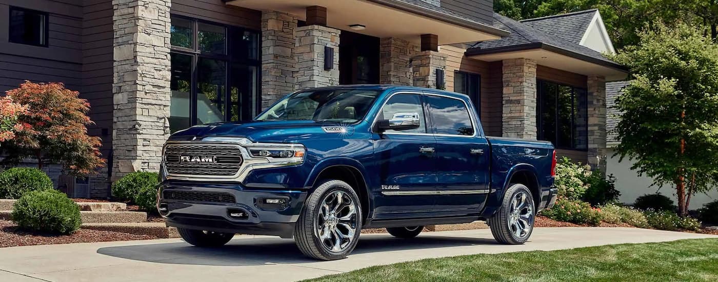 A blue 2024 Ram 1500 parked in a driveway.
