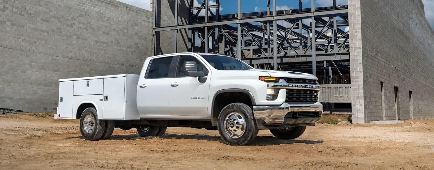 A white 2024 Chevy Silverado 3500 HD parked at a construction site.